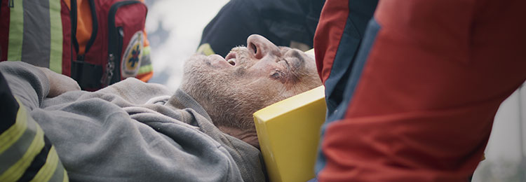 Injured man on stretcher, highlighting catastrophic injuries - Law Offices of Daniel L. Clayton