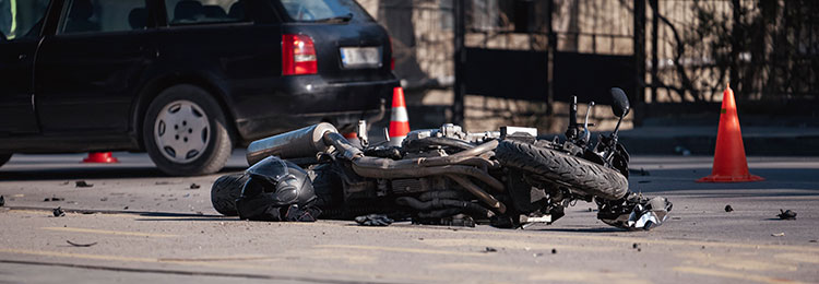 Motorcycle accident with fallen bike and car, reckless driving - Law Offices of Daniel L. Clayton
